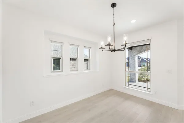 a view of a room with a ceiling fan and window