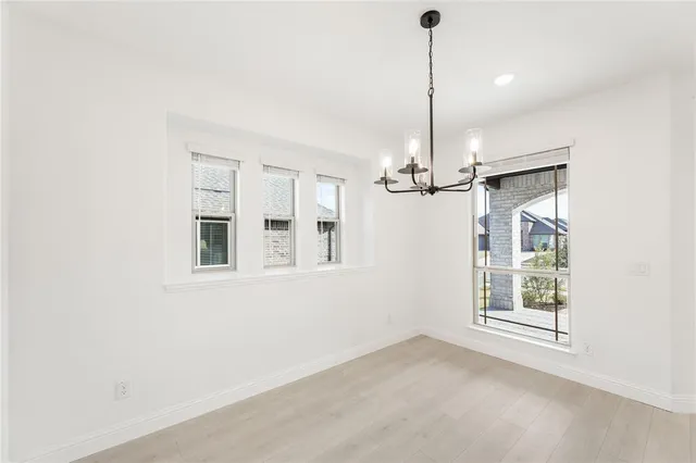 a view of a room with a ceiling fan and window