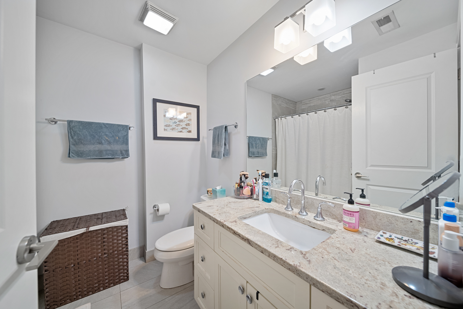 1041 West Madison Street, Unit 3 Chicago, IL 60607 - Photo 14 of 25 a bathroom with a granite countertop sink a toilet and a mirror