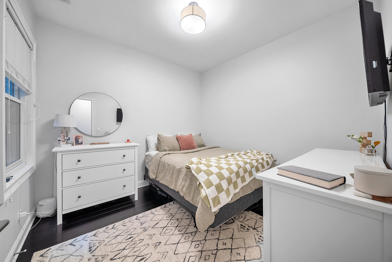 1041 West Madison Street, Unit 3 Chicago, IL 60607 - Photo 16 of 25 a bedroom with a bed and a flat tv screen on dresser