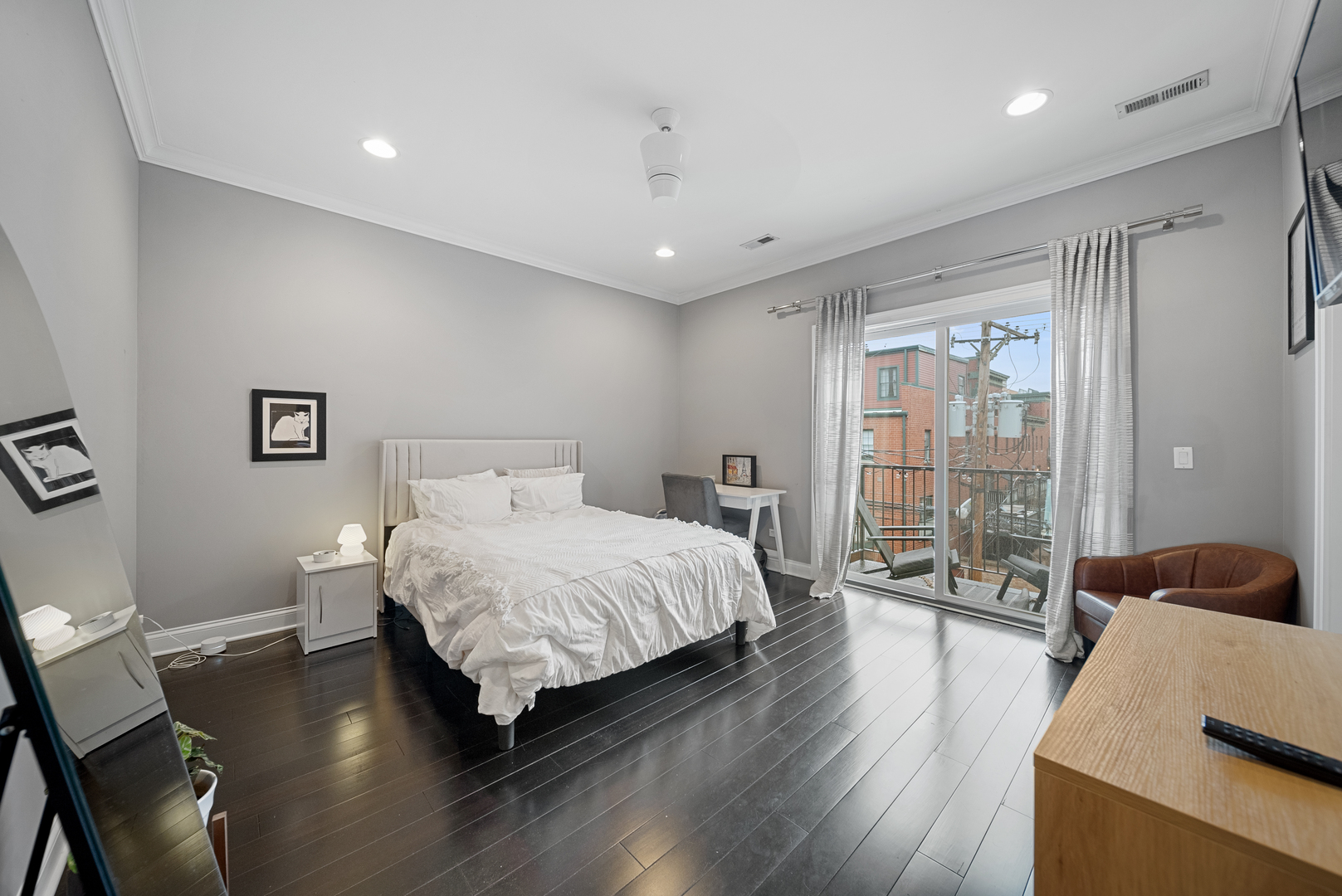 1041 West Madison Street, Unit 3 Chicago, IL 60607 - Photo 17 of 25 a spacious bedroom with a bed and wooden floor