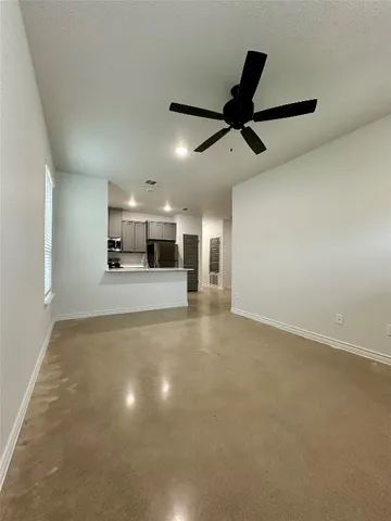 an empty room with entrance and windows