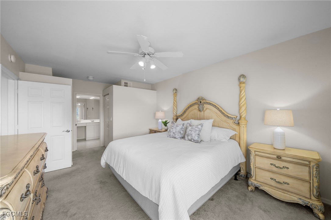 10831 Halfmoon Shoal Road, Unit 104 Estero, FL 34135 - Photo 12 of 49 a bedroom with a bed and a dresser