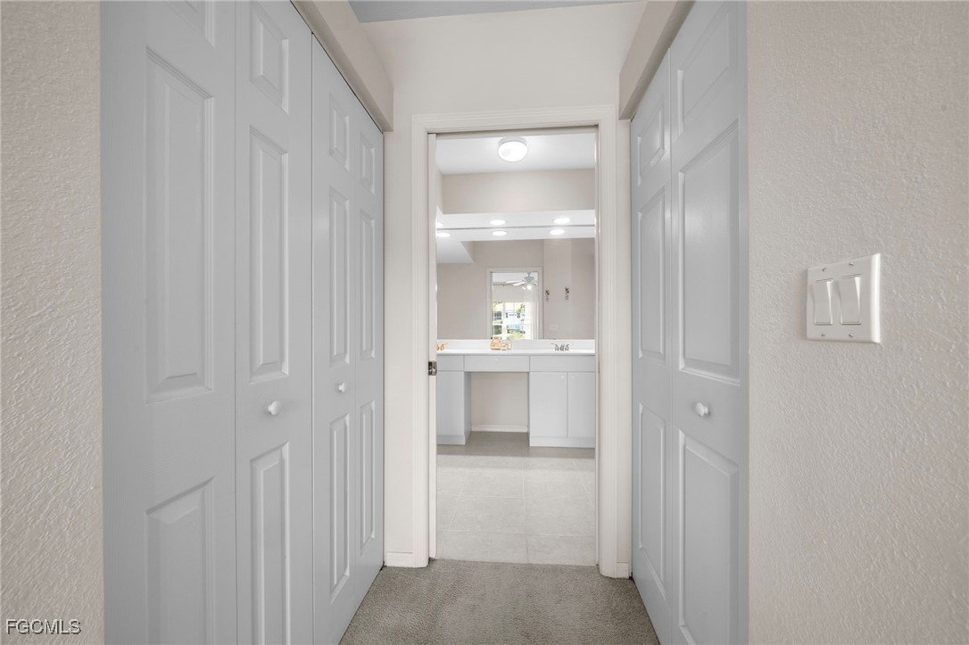 10831 Halfmoon Shoal Road, Unit 104 Estero, FL 34135 - Photo 13 of 49 a bathroom with a sink and a mirror
