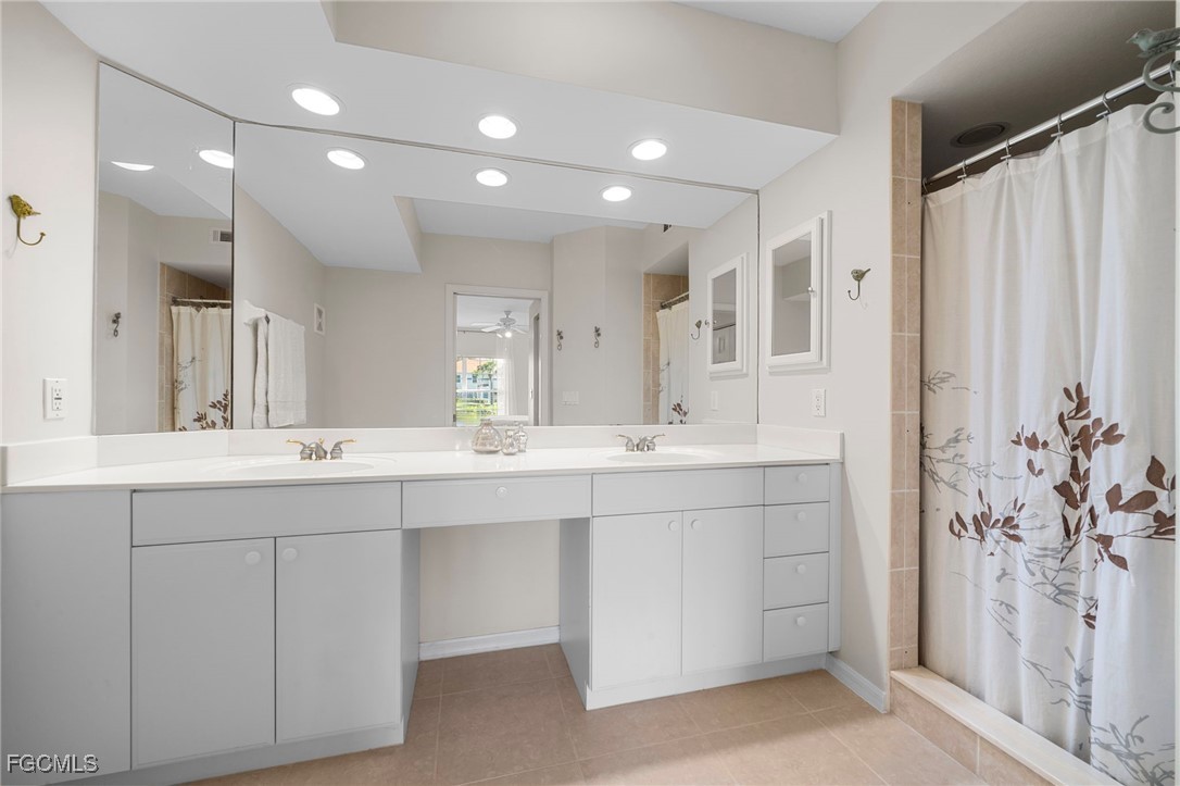 10831 Halfmoon Shoal Road, Unit 104 Estero, FL 34135 - Photo 14 of 49 a bathroom with a double vanity sink mirror and