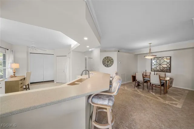 a living room with furniture and kitchen view