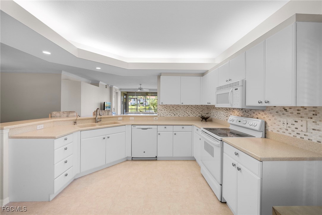 10831 Halfmoon Shoal Road, Unit 104 Estero, FL 34135 - Photo 18 of 49 a kitchen with sink and cabinets