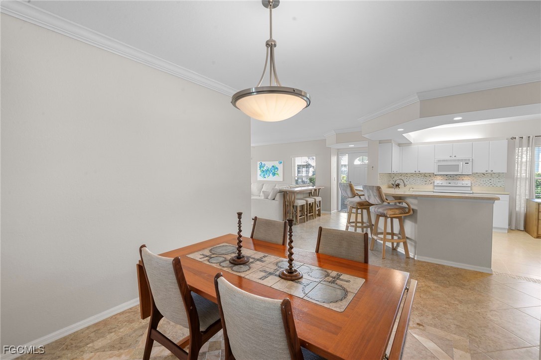 10831 Halfmoon Shoal Road, Unit 104 Estero, FL 34135 - Photo 21 of 49 a dining room with furniture and window