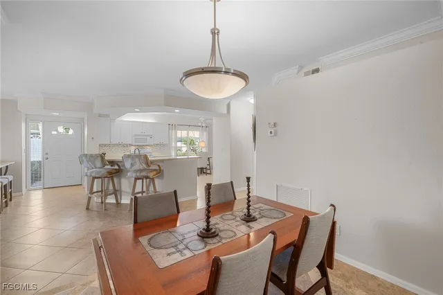 a bedroom with two beds and a chandelier