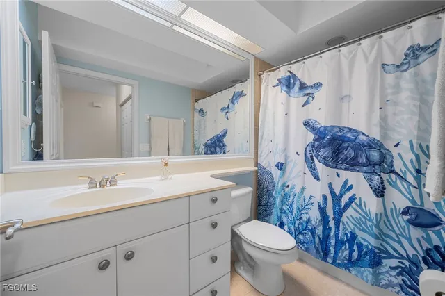 a bedroom with a bed and a ceiling fan