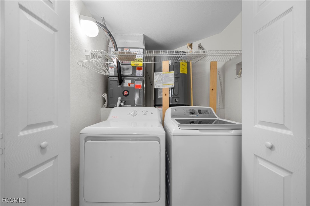 10831 Halfmoon Shoal Road, Unit 104 Estero, FL 34135 - Photo 28 of 49 a utility room with dryer and washer