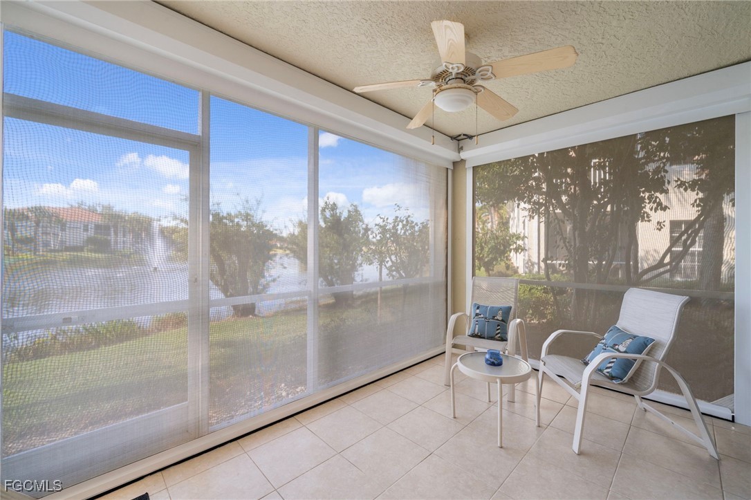 10831 Halfmoon Shoal Road, Unit 104 Estero, FL 34135 - Photo 31 of 49 a view of a dining room with furniture large windows and wooden floor