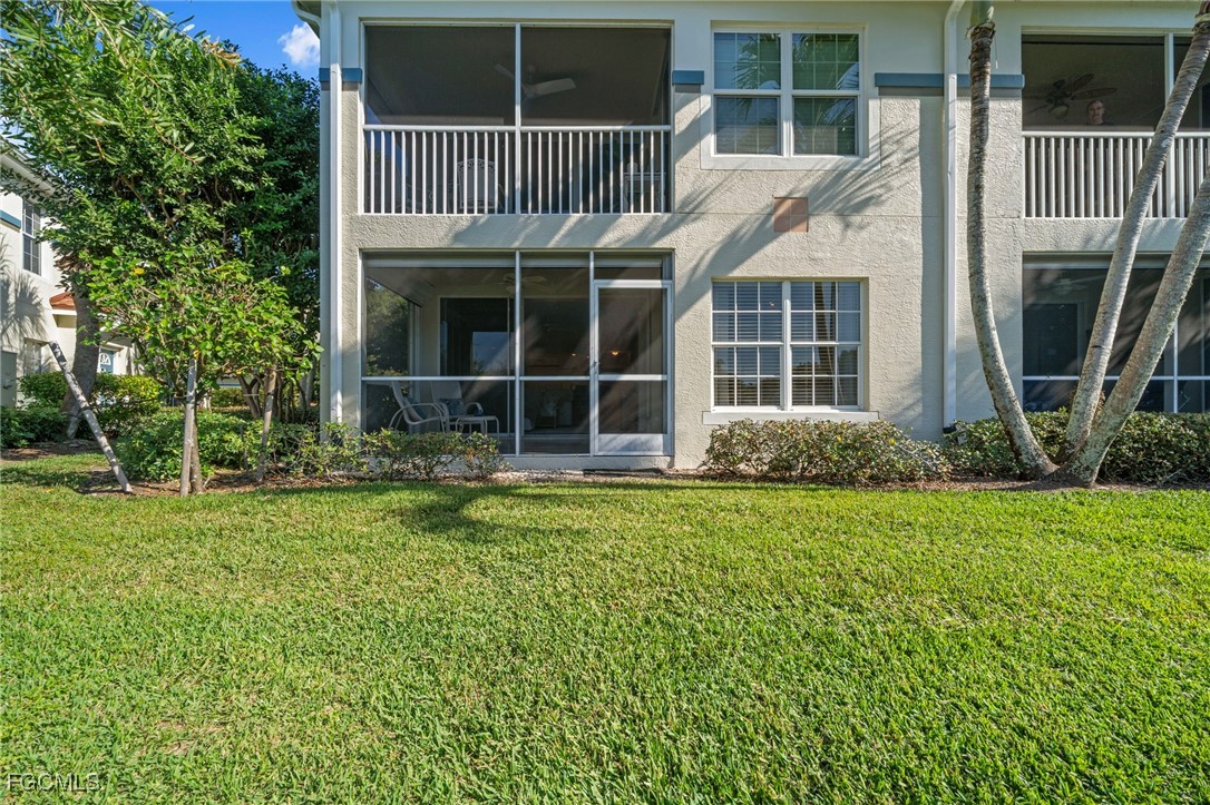10831 Halfmoon Shoal Road, Unit 104 Estero, FL 34135 - Photo 34 of 49 a front view of a house with a garden