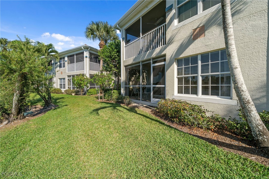 10831 Halfmoon Shoal Road, Unit 104 Estero, FL 34135 - Photo 35 of 49 a view of house with yard and sitting area