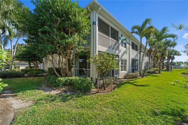 a front view of house with yard and car parked