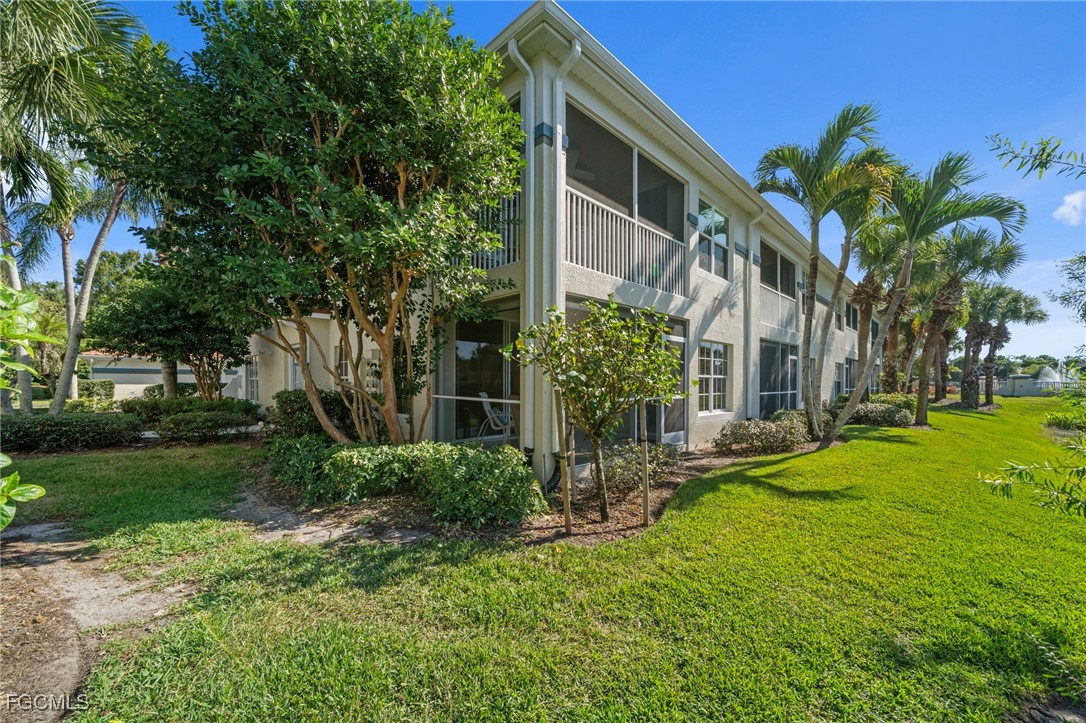 10831 Halfmoon Shoal Road, Unit 104 Estero, FL 34135 - Photo 36 of 49 a view of a yard with plants and trees