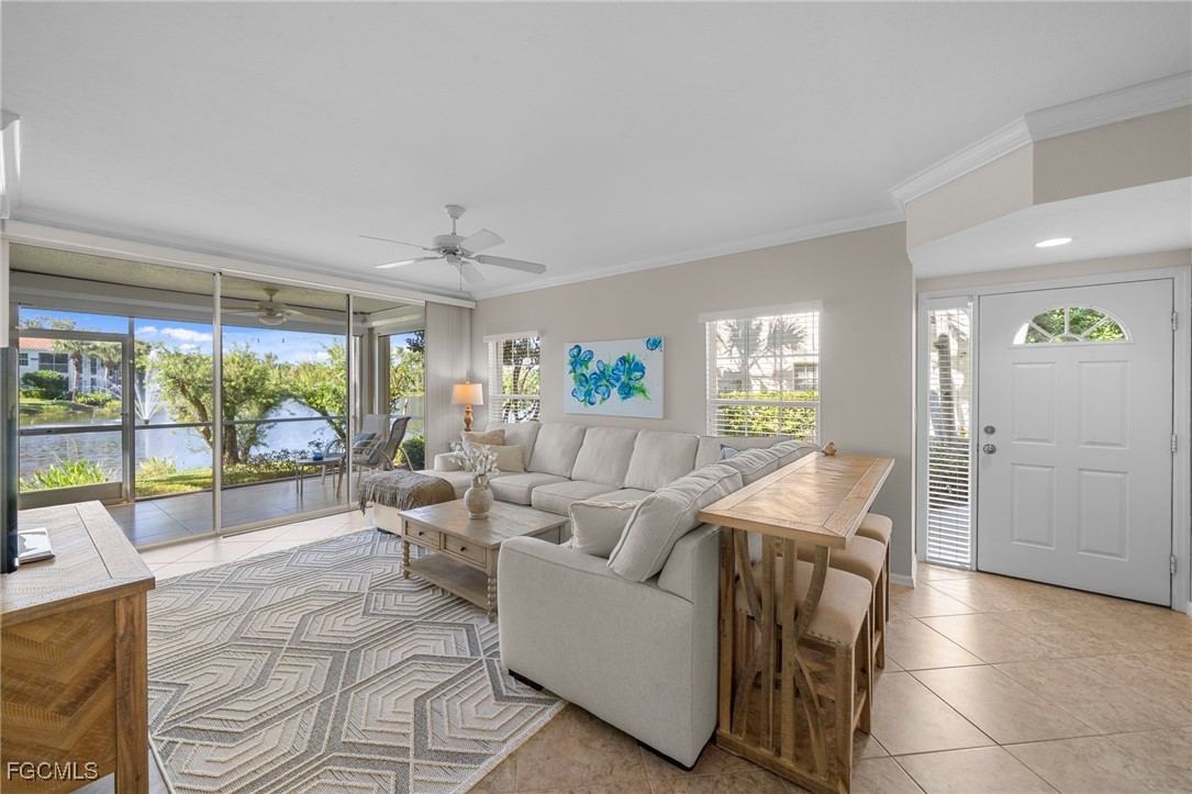 10831 Halfmoon Shoal Road, Unit 104 Estero, FL 34135 - Photo 4 of 49 a living room with furniture and a large window