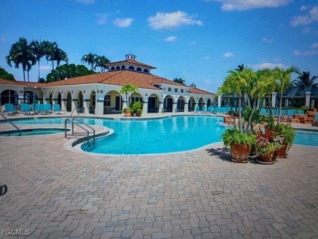 10831 Halfmoon Shoal Road, Unit 104 Estero, FL 34135 - Photo 41 of 49 a view of a house with a yard and potted plants