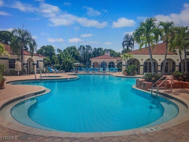 10831 Halfmoon Shoal Road, Unit 104 Estero, FL 34135 - Photo 42 of 49 a view of a swimming pool with outdoor seating