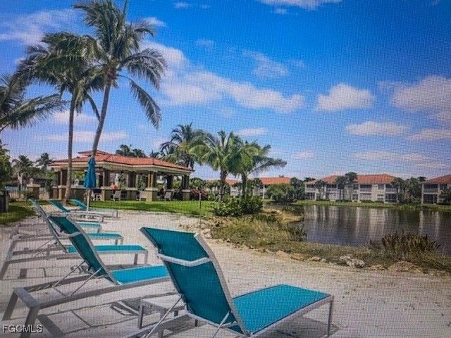 10831 Halfmoon Shoal Road, Unit 104 Estero, FL 34135 - Photo 43 of 49 a view of a lake with couches and city view