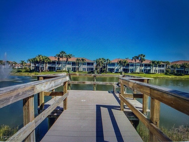 10831 Halfmoon Shoal Road, Unit 104 Estero, FL 34135 - Photo 44 of 49 a view of a lake with a terrace