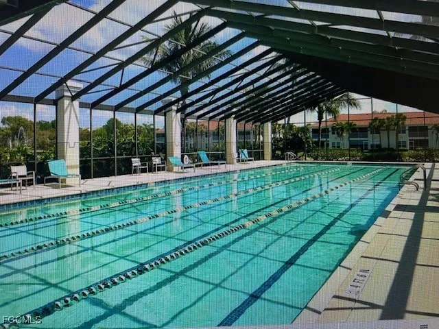 a living room with lots of gym equipment and a large window