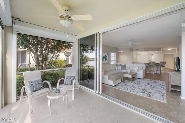 a living room with furniture a rug and white walls