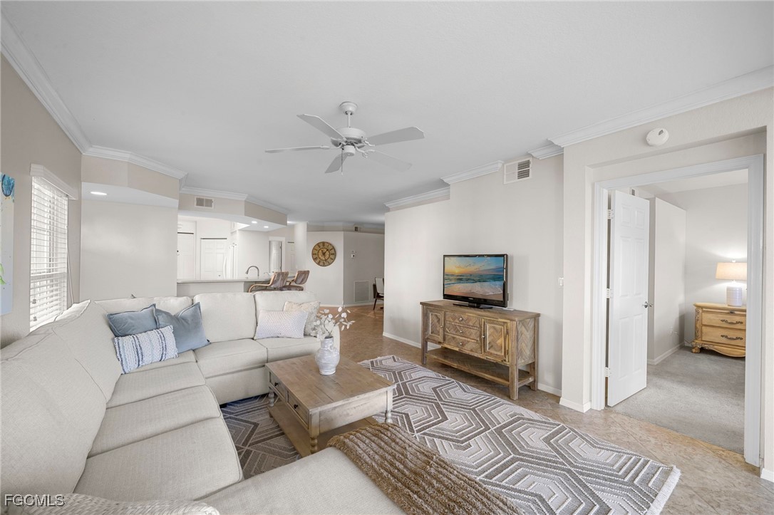 10831 Halfmoon Shoal Road, Unit 104 Estero, FL 34135 - Photo 9 of 49 a living room with furniture and a wooden floor