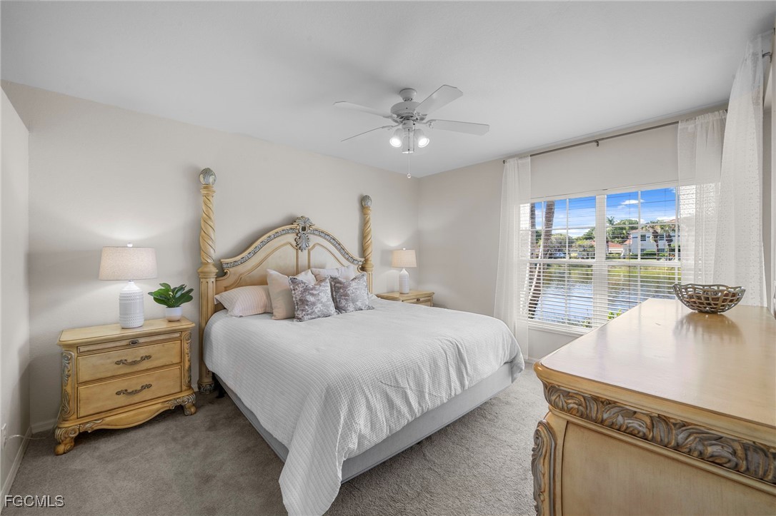10831 Halfmoon Shoal Road, Unit 104 Estero, FL 34135 - Photo 10 of 49 a bedroom with a bed and a night stand