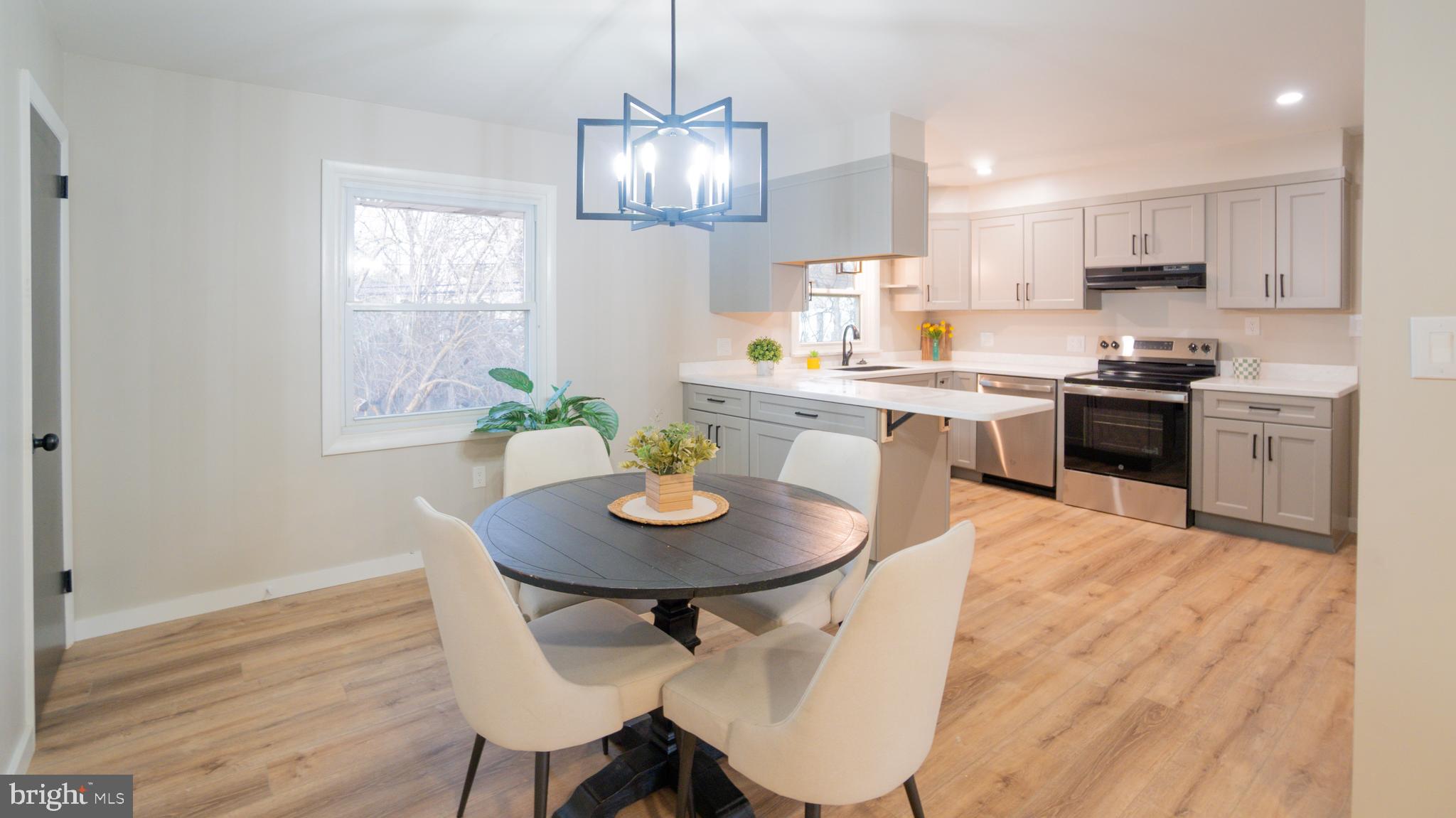 3420 Belair Road Harrisburg, PA 17109 - Photo 4 of 34 a kitchen with a dining table chairs stainless steel appliances and cabinets
