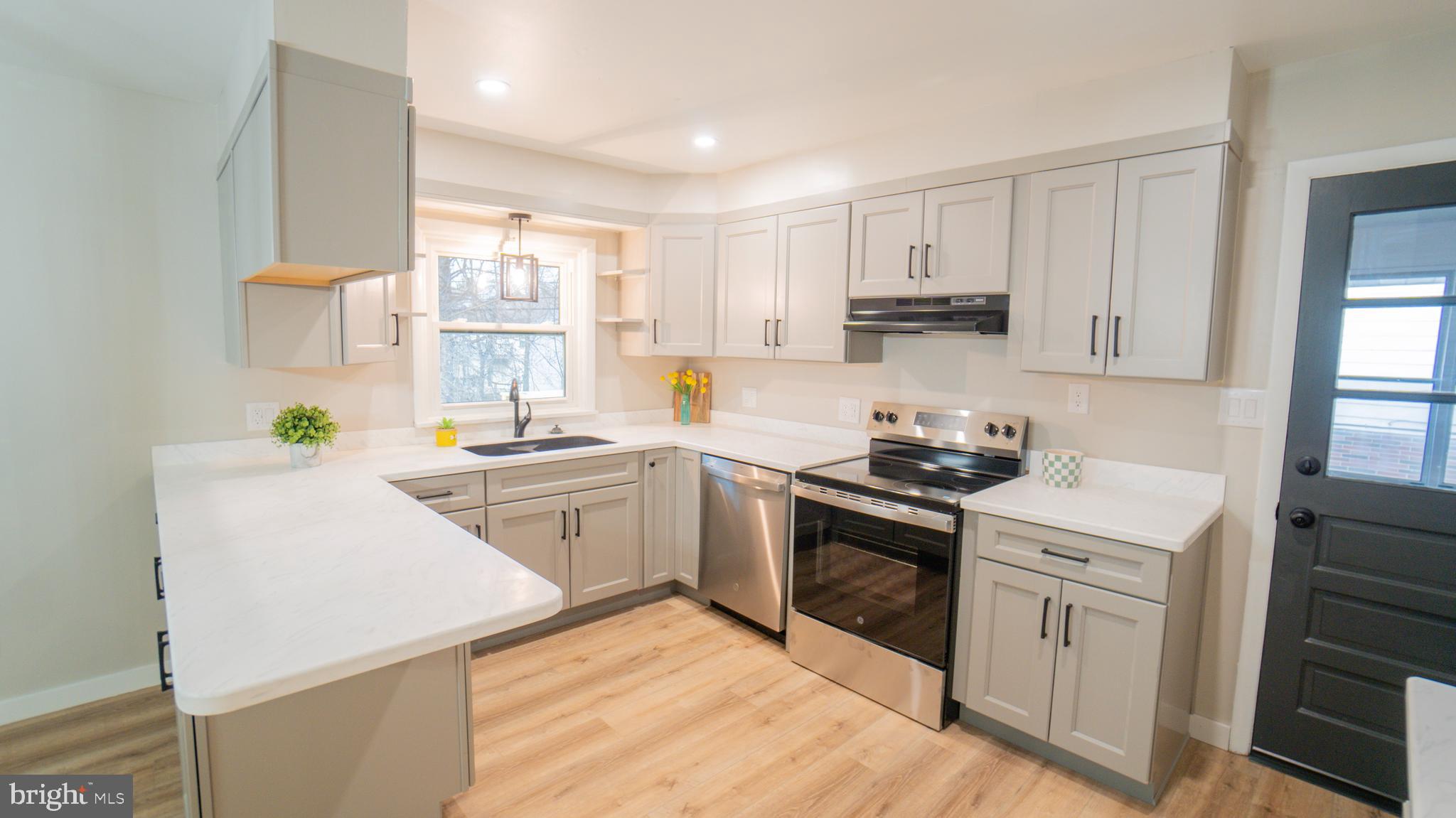 3420 Belair Road Harrisburg, PA 17109 - Photo 7 of 34 a kitchen with white cabinets stainless steel appliances and sink