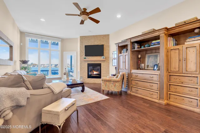 a living room with furniture a fireplace and a flat screen tv