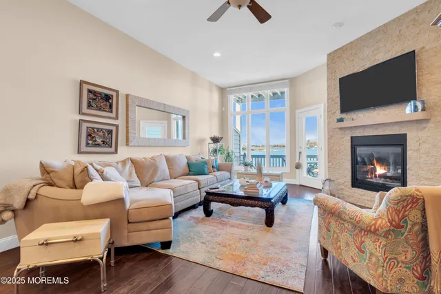 a living room with furniture fireplace and flat screen tv