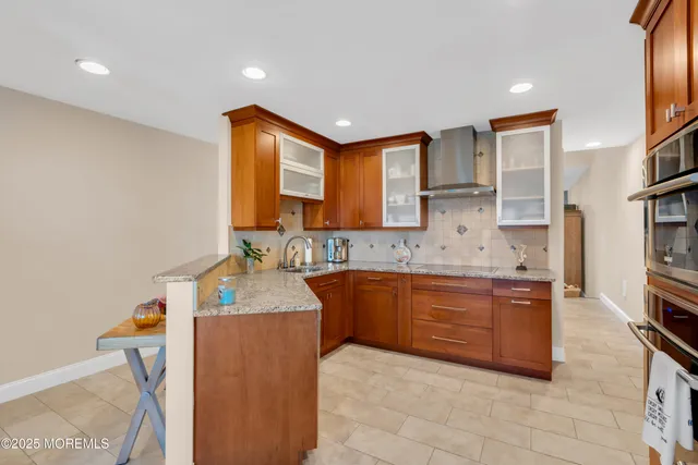 a kitchen with stainless steel appliances granite countertop a sink and a refrigerator