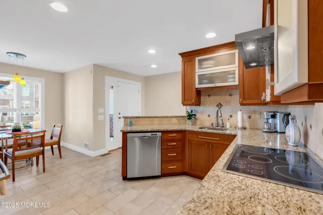 a kitchen with stainless steel appliances granite countertop sink stove and granite counter top