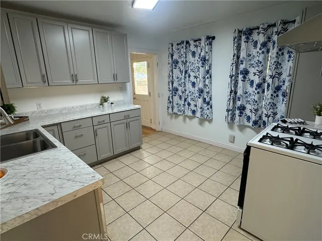 a kitchen with a stove sink and cabinets