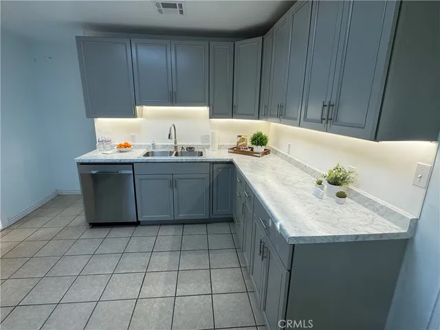 a kitchen with a sink a stove and cabinets