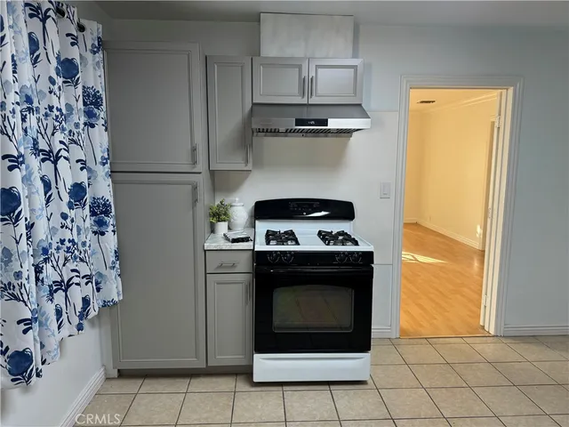 a stove top oven sitting inside of a kitchen
