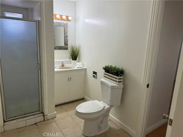 a bathroom with a toilet a sink and a mirror