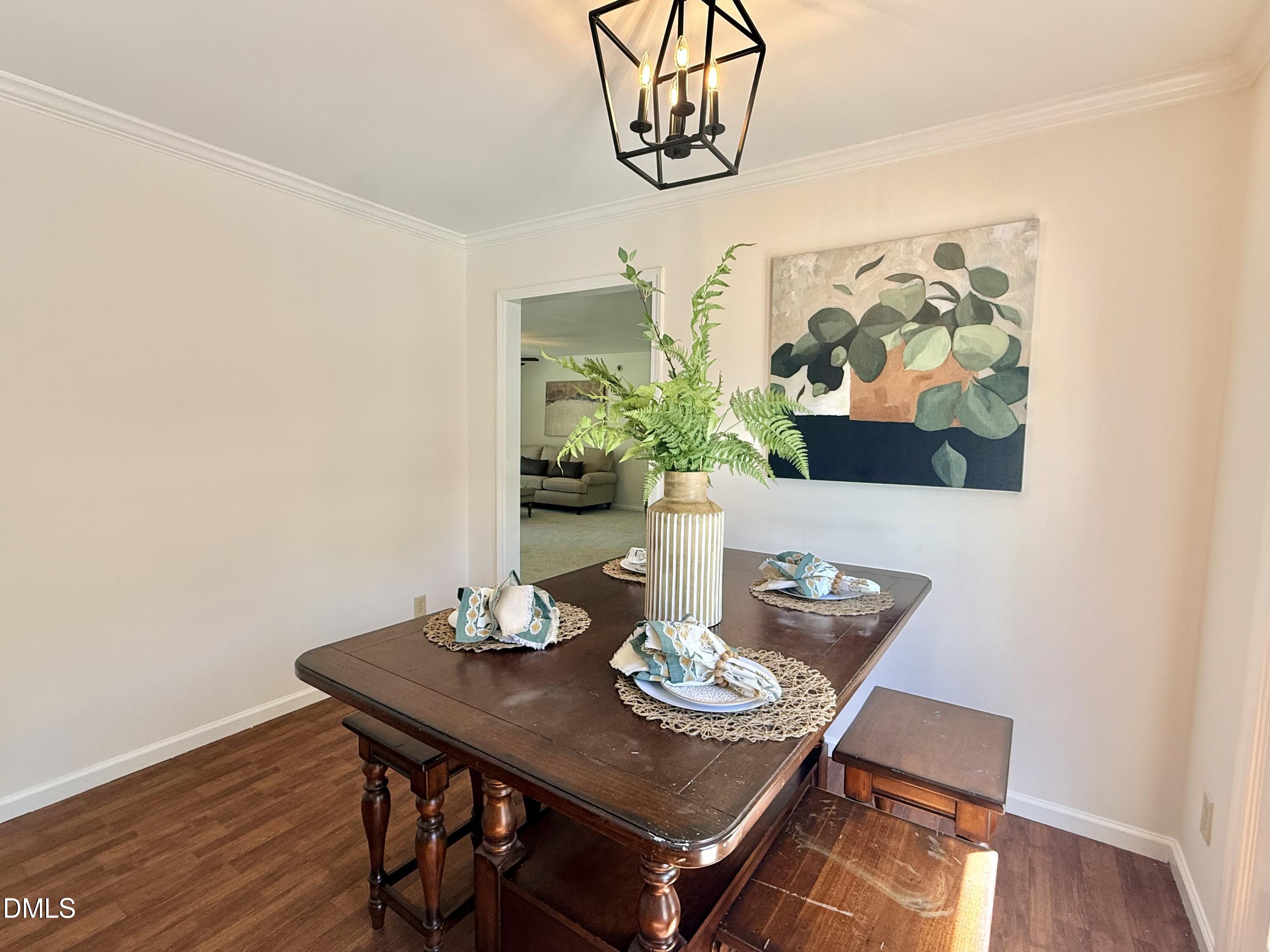 2429 Halifax Road Roxboro, NC 27573 - Photo 19 of 54 a view of a dining room with furniture and wooden floor