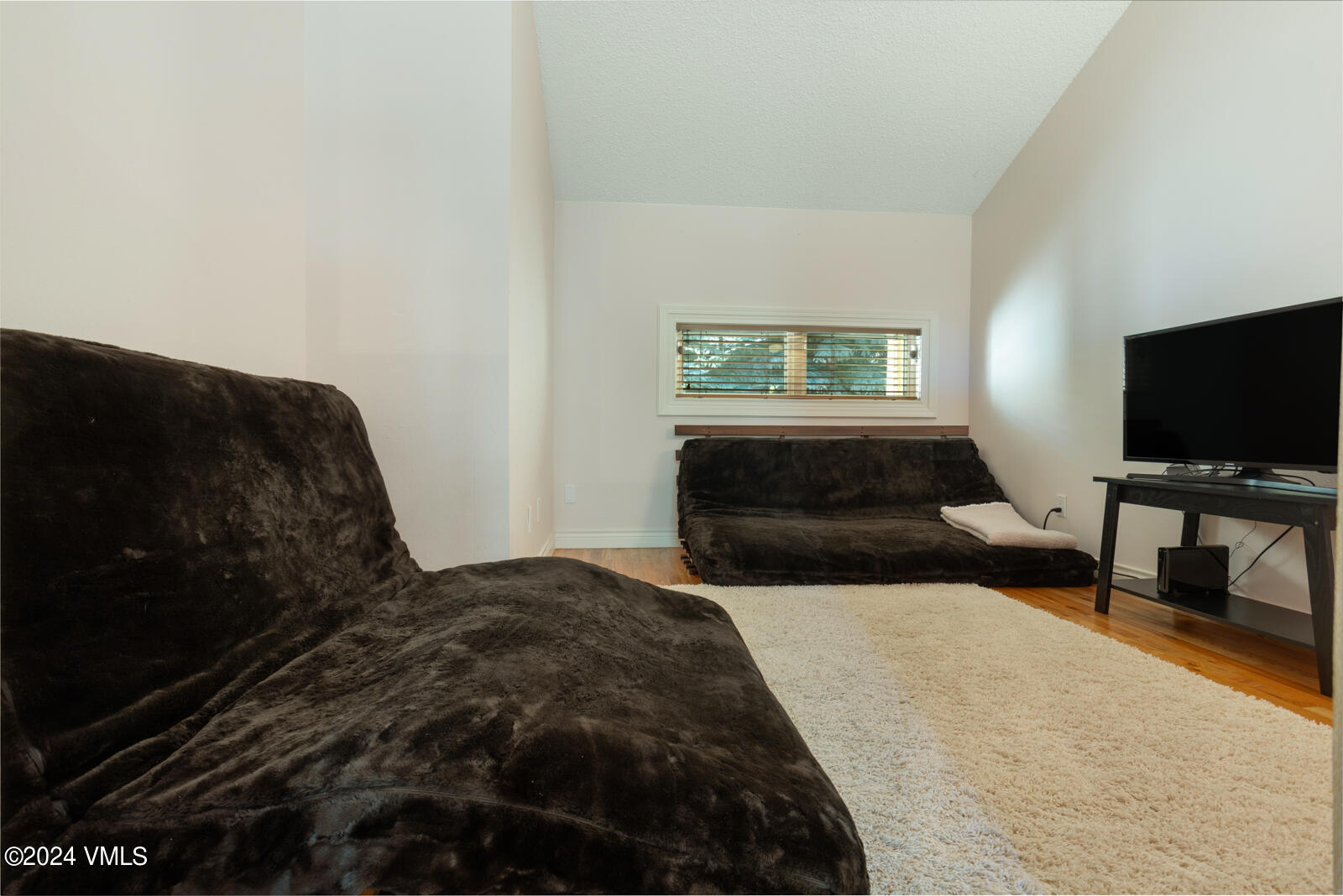 18 Beaver Road, Unit 1 Avon, CO 81620 - Photo 30 of 46 a bedroom with a bed and a flat screen tv