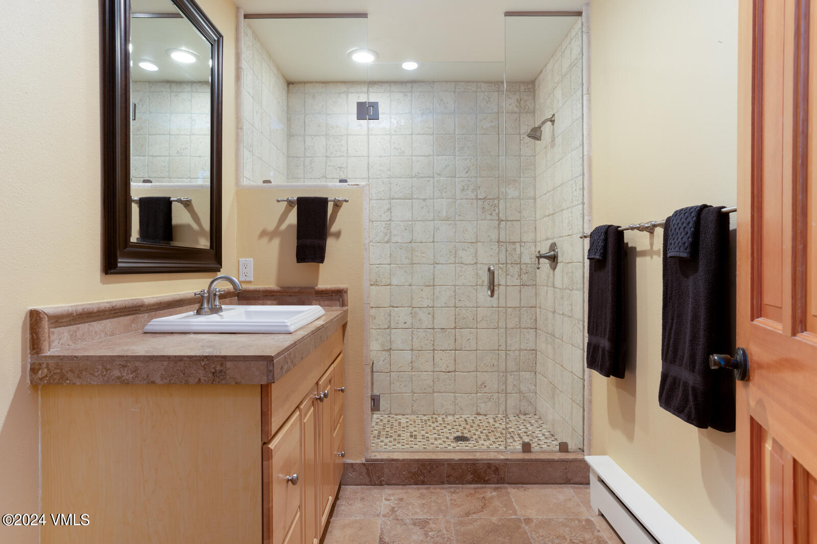 18 Beaver Road, Unit 1 Avon, CO 81620 - Photo 32 of 46 a bathroom with a double vanity sink a mirror and shower