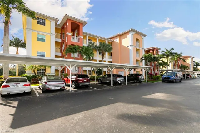 a view of a cars park in front of a building