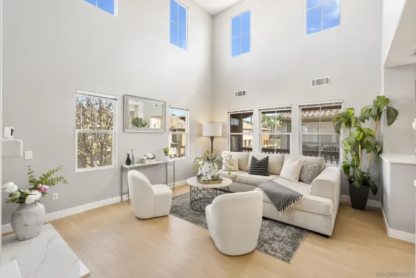 a living room with furniture and a potted plant