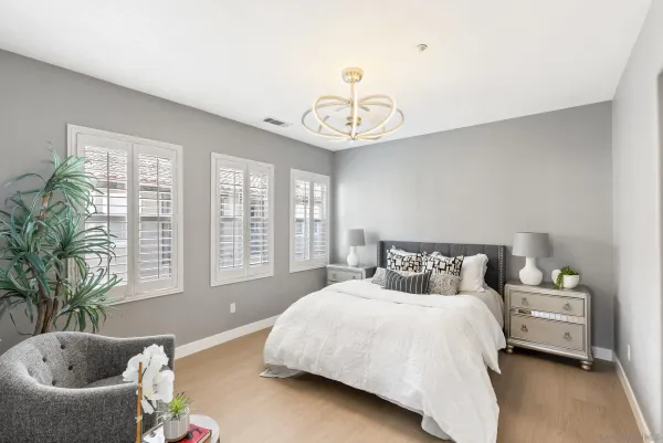 a bedroom with a bed and a chandelier