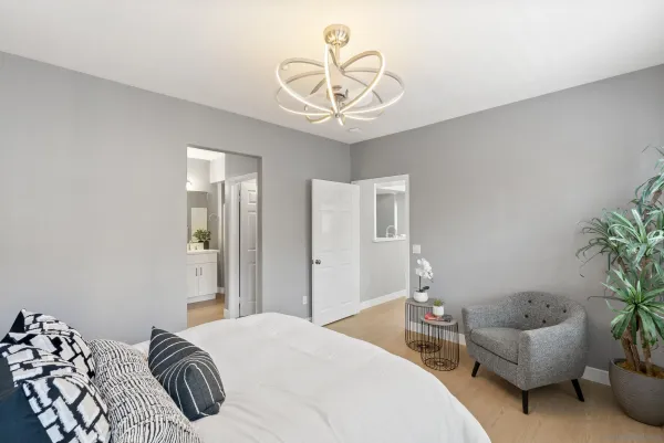a bedroom with a bed and a chandelier
