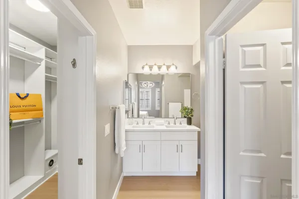 a bathroom with a sink a mirror a vanity and a shower