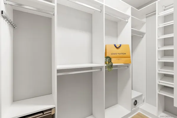 a bathroom with a walk in closet and a window
