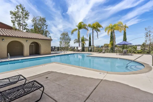a view of pool with two chairs and a table