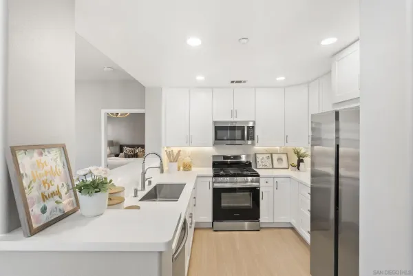 a kitchen with stainless steel appliances kitchen island granite countertop a refrigerator sink and stove
